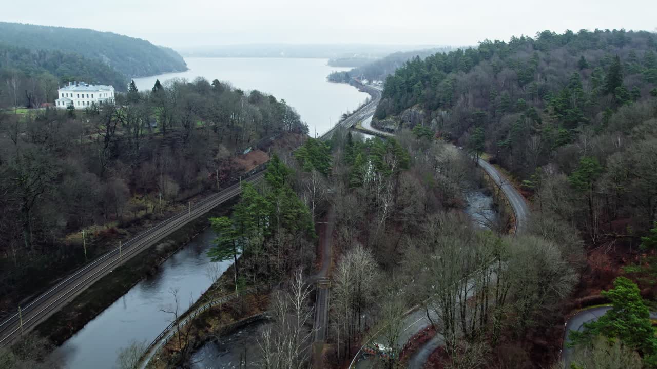 Drone aerial of Jonsered village and Save River near Gothenburg, Sweden, captured during a calm, misty morning in soft, diffused light