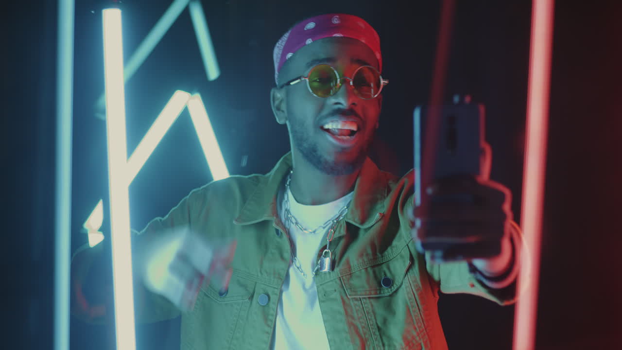 Stylish Man Taking a Selfie Under Neon Lights