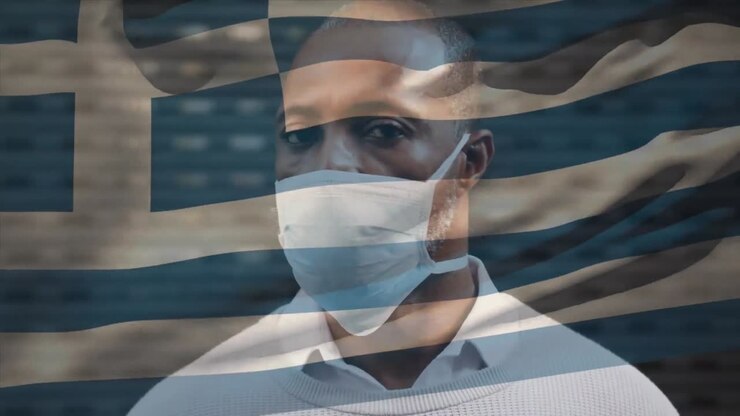 Animation of flag of greece waving over man wearing face mask during covid 19 pandemic