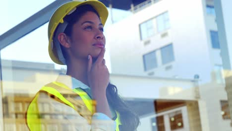 engineer-looking-outside-window-at-building