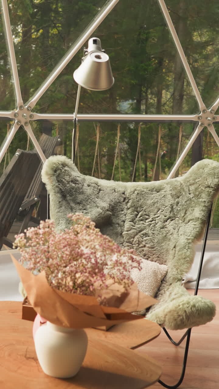 Glass balcony in glamping hotel bungalow for tourists. Stunning views with relaxation space for guests. Terrace with cozy chair to enjoy scenic landscape