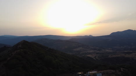 A-drone-rises-over-a-ranch-in-the-mountains-of-Pico-De-Los-Reales,-Estepona,-Spain