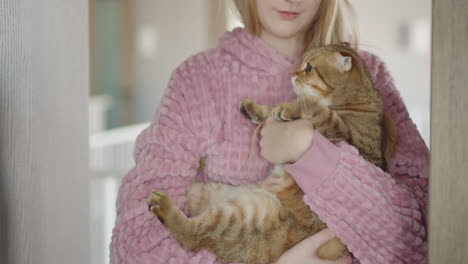 girl hugging a cat