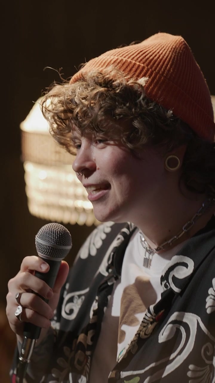 Female Gen Z Performer Speaking in Mic during Standup Show on Stage
