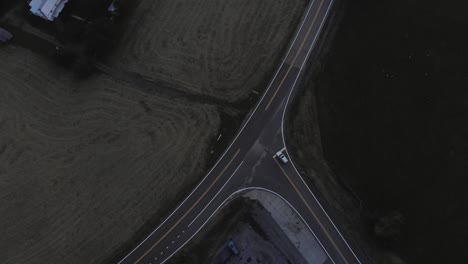 Aerial,-top-down-shot-of-a-vehicle-making-a-stop-at-a-T-junction