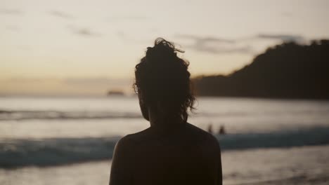 Man-Contemplate-At-The-Shore-Of-A-Calm-Ocean-During-Sunset