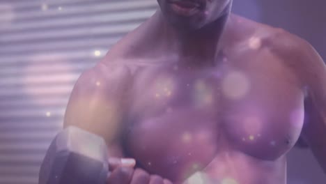 animation of glowing spots over strong man exercising in gym