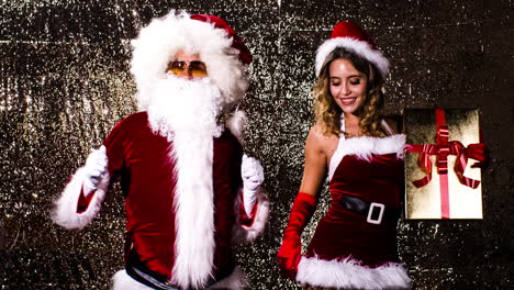 santa claus and woman in xmas costume dance for christmas time disco shoot