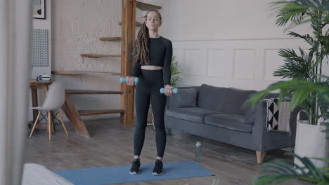 woman doing dumbbell arm workout at home