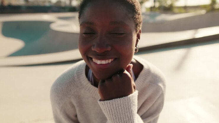 Young African American Woman Smiling and Looking Away in Park