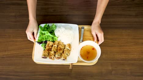 hands arranging a traditional vietnamese meal