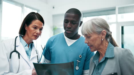 doctor and nurse discussing x-ray with patient