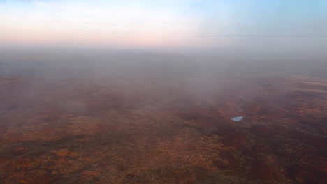 Aerial-flight-through-dense-clouds-covering-heather-and-moor-of-Kinder-Scout-Mountain