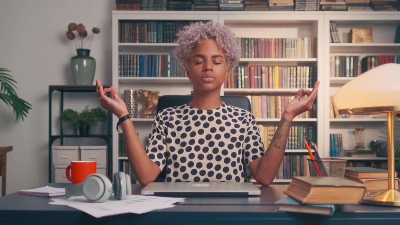 Business woman meditating at workplace at home office stress relieving exercise