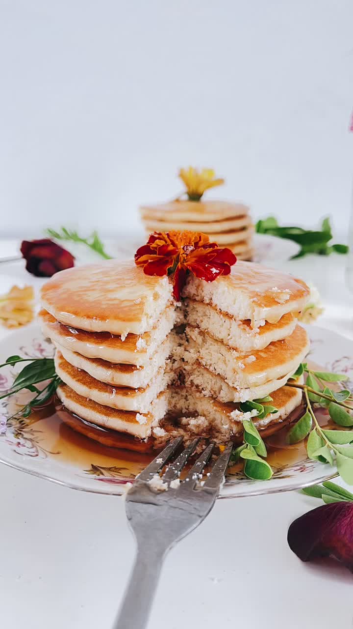 Delicious Stacked Pancakes with Syrup and Flowers