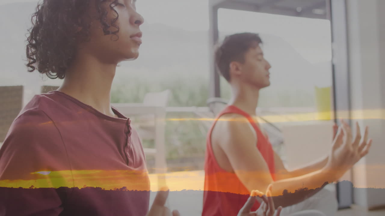 Meditating with sunset landscape overlay, two people in peaceful setting