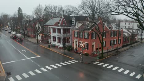 tractor trailer rig and tanker truck pass through small town in usa