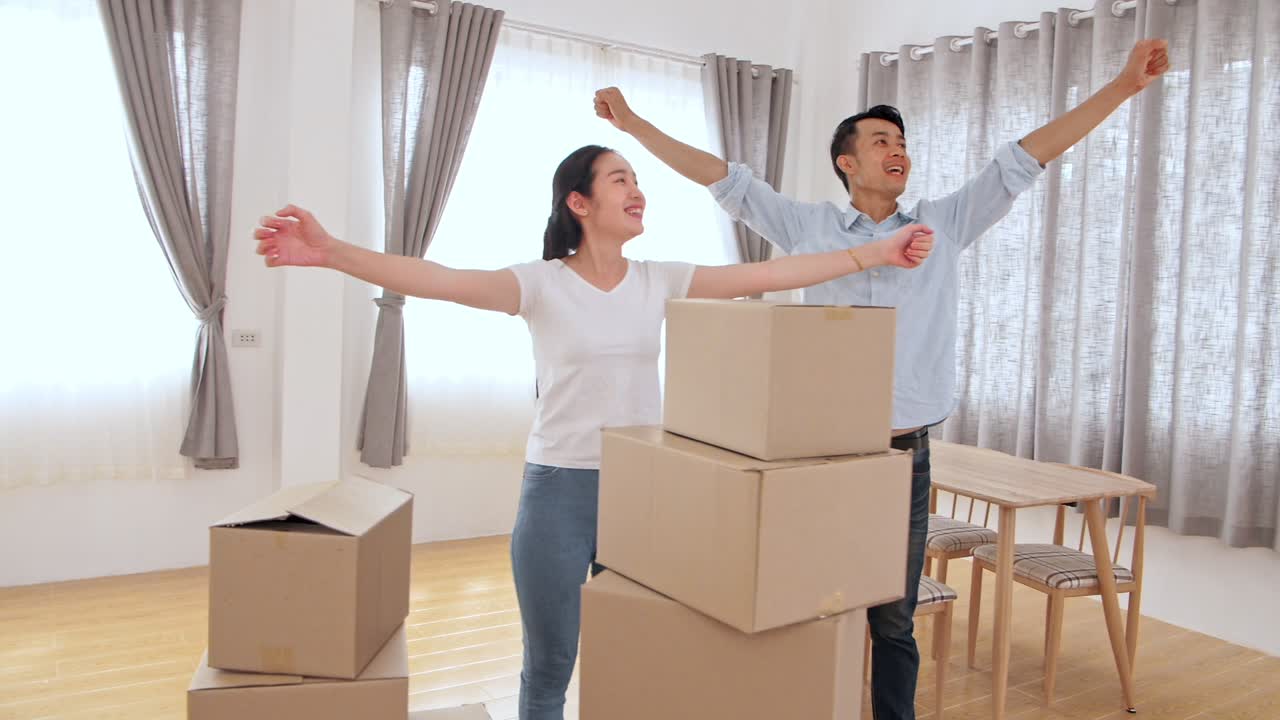 Happy Asian Couple In New House