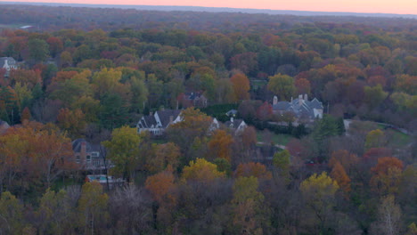 slow push towards beautiful houses and trees in autumn at sunset in ladue in st