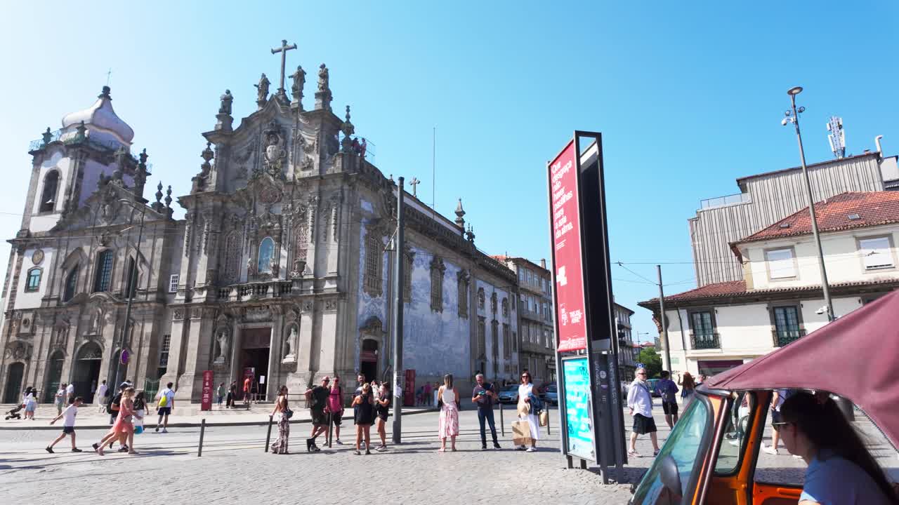 Historic Igreja do Carmo in Porto with tourists walking in a sunny square