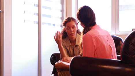 female patient having discussion with therapist