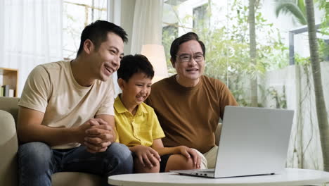 asian men and boy in the living room