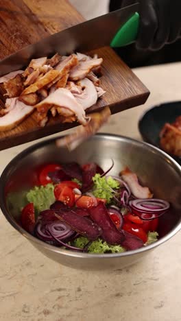 preparing a chicken and smoked meat salad