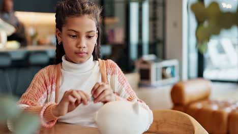 girl saving money in a piggy bank