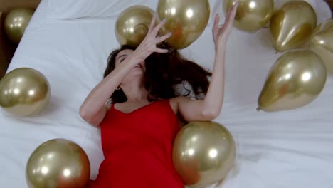 collection of golden reflective balloons and beautiful model