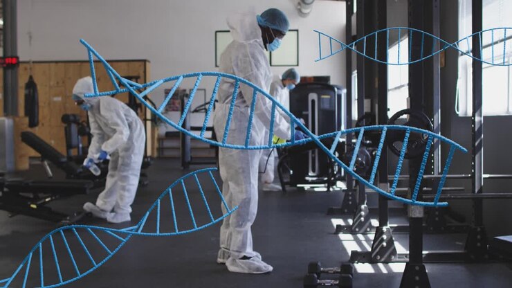 Left worker starting cleaning, gym worker using sprayer on racks, team sanitizing under DNA helix