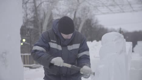 ice sculptor at work in winter