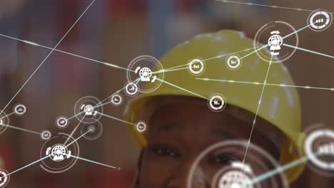 Animation-of-connected-graphs-and-people-with-globe-icons-over-african-american-man-wearing-hardhat