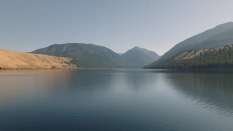 Aerial-moving-over-hazy-mountain-lake-in-western-USA