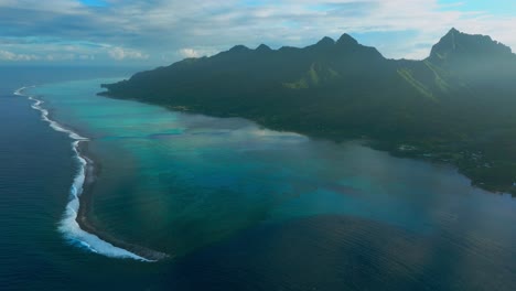 morning sunrise moorea island cooks opunohu bay french polynesia aerial drone lagoon coral reef mount mauaroa tohivea rotui jagged peaks haapiti paopao pacific ocean blue sky sun flare backwards