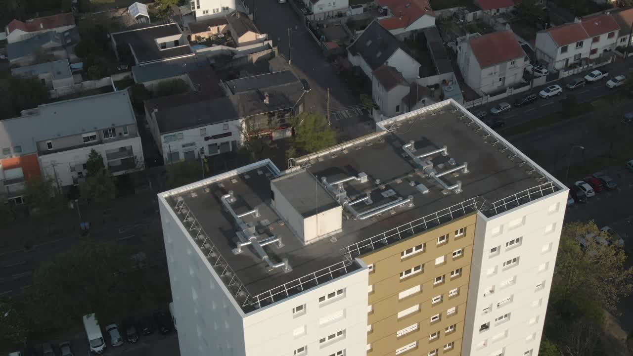 Drone flying over modern residential building in Nantes, showing rooftop details and facade architecture. Urban living, real estate close-up, France