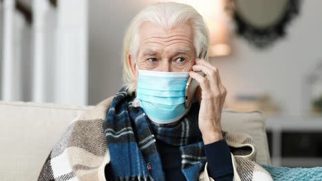 sick man wearing a medical mask and calling on cellphone