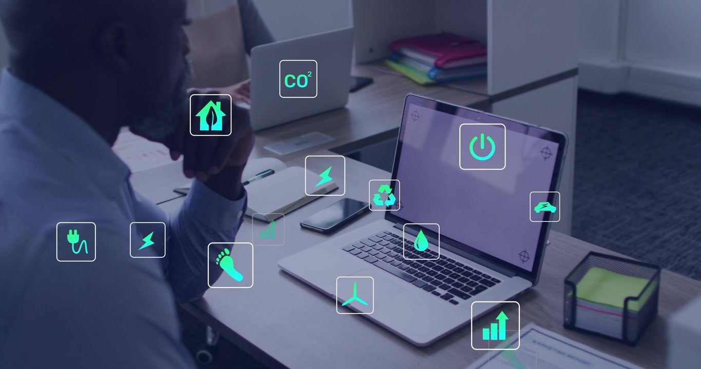 Analyst watching laptop as dashboard loading, icons clustering around desk, visualizing energy data