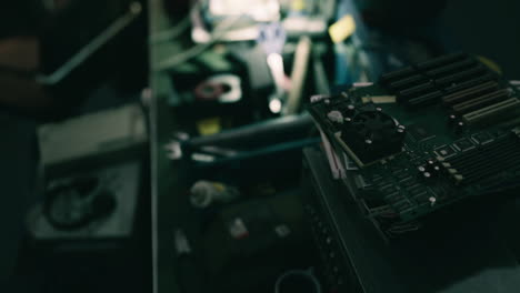 detailed view of circuit board and electronics in a workshop setting at night