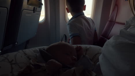 baby with mom and brother in landing plane