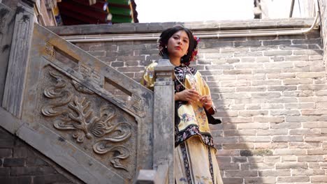 qing dynasty woman in traditional clothing poses on stairs with ornate reliefs