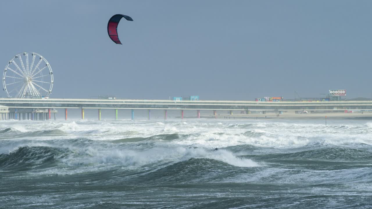 Stormy Beach with Kitesurfing and Pier