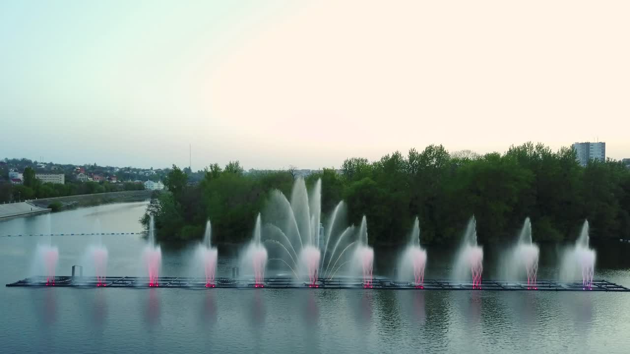 Music Fountain On The River. Aerial shot of the beautiful performance of colorful fountains