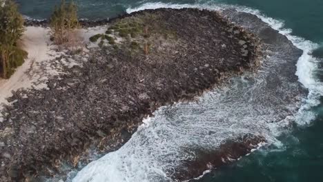 Drone-aerial-beach-pan-up-surfers-waves-mountains