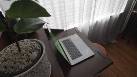 modern home office with silver laptop as camera moves up slowly