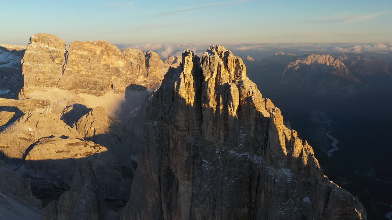 Cinematic drone shot of Tre Cime di Lavaredo in Italy, moving closer to peak with slow rotation