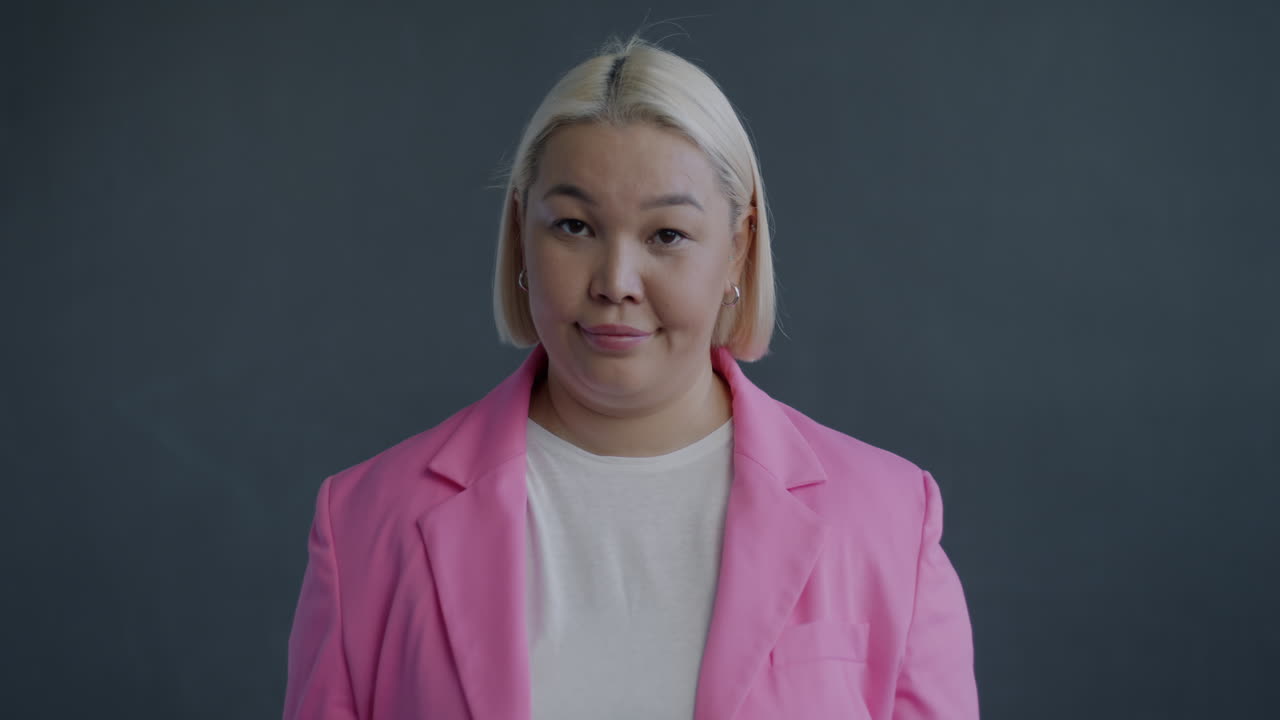 Woman in a pink jacket, rejecting