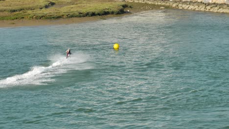 jetski expert taks a turn at high speed and sprays water everywhere - slow motion