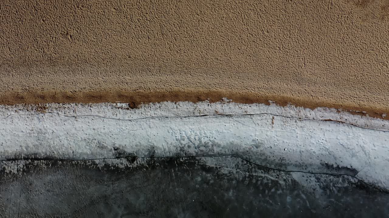 Aerial view of frozen lake shoreline and beach in winter on sunny day-1