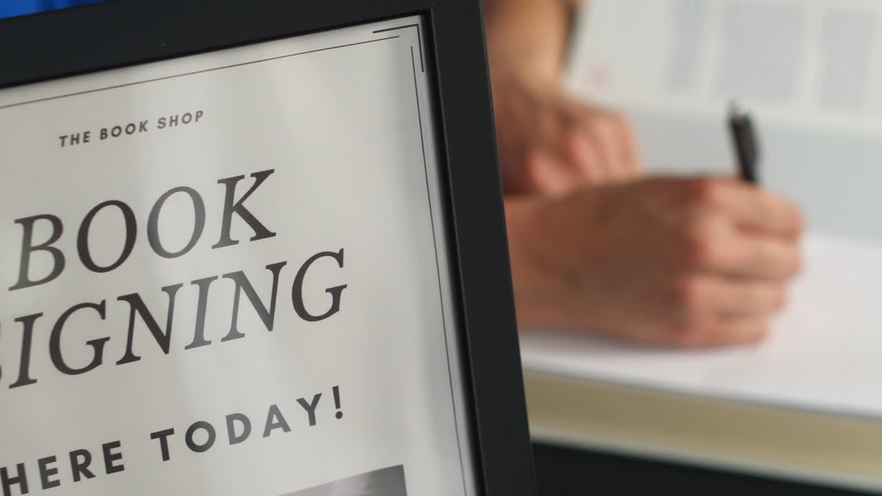 Unrecognizable author signing autographs at a book launch