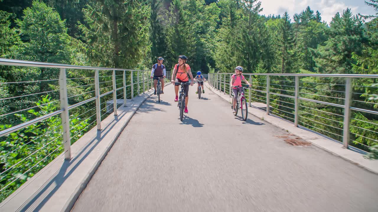 Active family ride bicycles in trail path Slovenia, tracking real-time